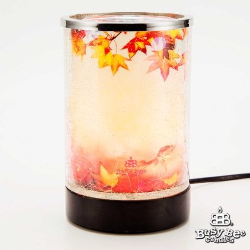 An Autumn Wax Warmer featuring falling leaves on an autumnal background